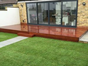 Timber decking with stone path and artificial grass