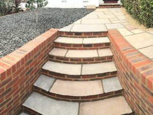 Brick stairs and patio with gravel flower bed