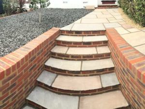 Brick stairs and path with gravel flower bed