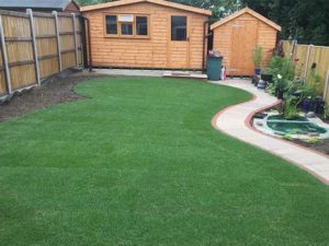 Timber sheds wth pathway and artificial grass