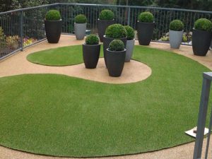 Shaped artificial grass with hedges
